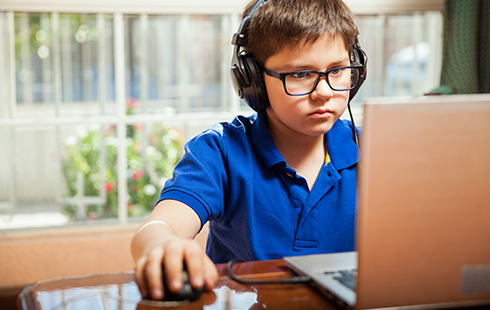 Boy at a laptop with headphones
