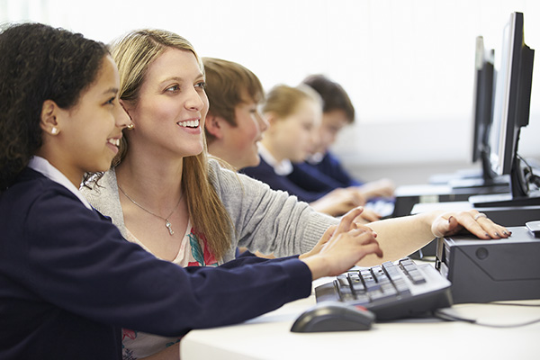 Teacher with Student at Computer