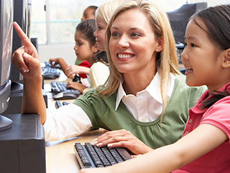 Teacher with students at computers