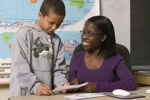 Teacher working on curriculum with student 